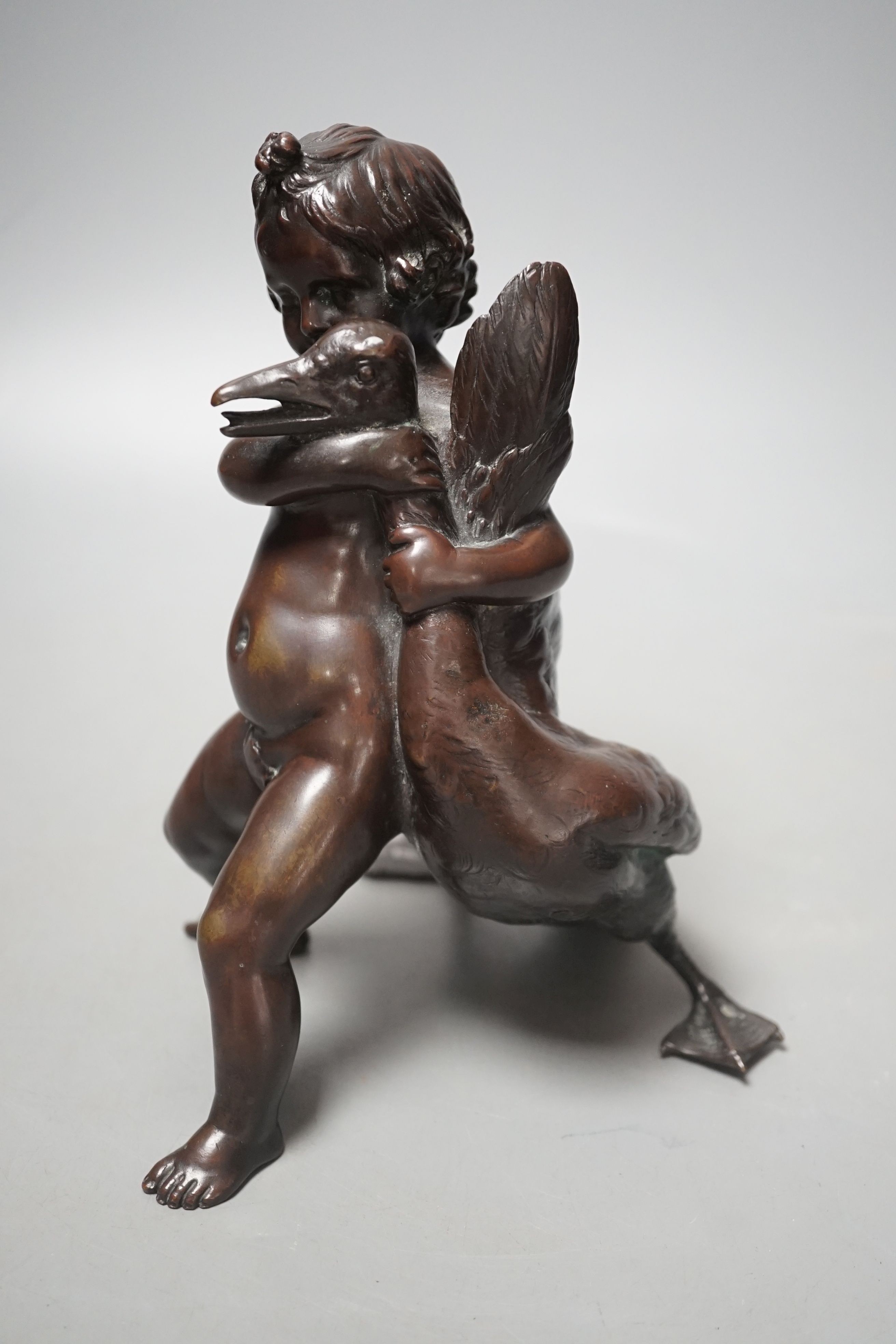 A Carl Karuba bronze of a cherub holding a goose, 17.5 cms high.